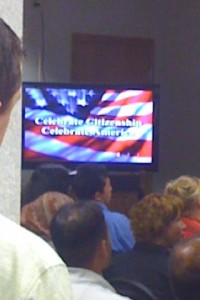 Video screen welcoming new American citizens